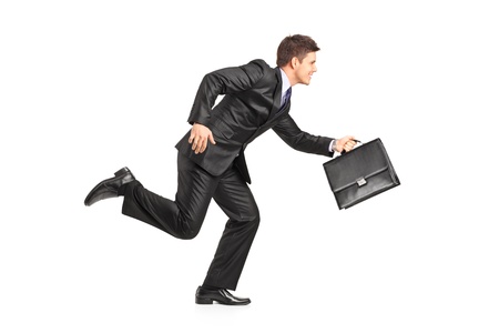 Businessman running with a briefcase isolated on white backgroundの写真素材