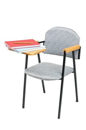 School chair with books on it, isolated on white backgroundの写真素材