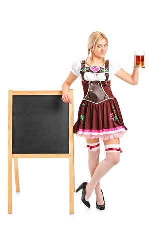 Full length portrait of a woman wearing traditional costume and holding a beer glass isolated on white background の写真素材