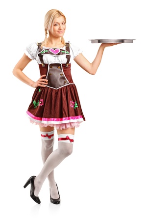 Full length portrait of a woman wearing traditional costume and holding an empty tray isolated on white backgroundの写真素材