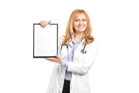 Portrait of a smiling healthcare professional holding a blank clipboard isolated on white backgroundの写真素材