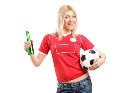 A portrait a blond female fan holding a beer bottle and football isolated on white backgroundの写真素材