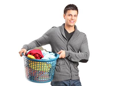 A portrait of a man holding a laundry basket isolated on white backgroundの写真素材