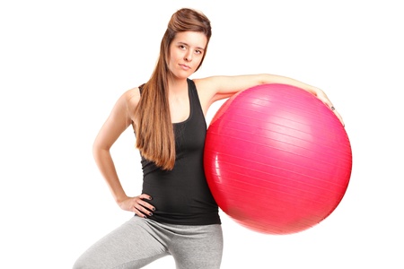 A portrait of a smiling female holding a fitness ball isolated on white backgroundの写真素材