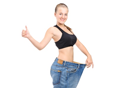A portrait of a weightloss woman giving a thumb up isolated on white backgroundの写真素材