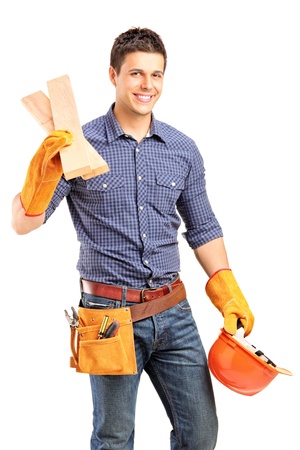 A smiling manual carpenter holding a helmet and sills isolated on white backgroundの写真素材
