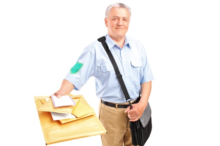 A smiling mature postman delivering letters isolated against white backgroundの写真素材