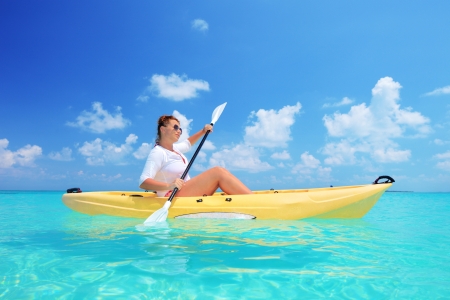 A woman kayaking on a sunny day, Kuredu island, Maldives, Lhaviyani atollの写真素材