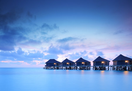 Water villa cottages at sunset on island of Kuredu, Maldives, Lhaviyani atollのeditorial素材