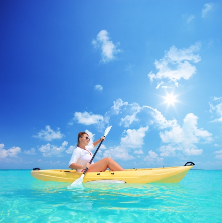 Woman kayaking on a sunny day, Kuredu island, Maldives, Lhaviyani atollの写真素材