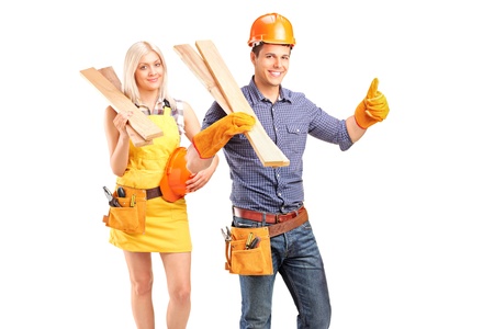 A smiling carpenter team of man and woman holding sills isolated on white backgroundの写真素材