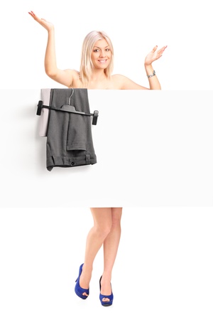 Full length portrait of a happy woman dressing up, looking behind dressing panel isolated on white backgroundの写真素材