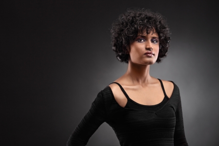 Portrait of an indian woman posing isolated on black backgroundの写真素材