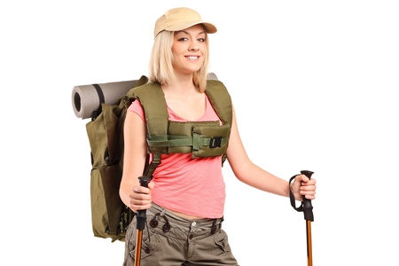 A woman in sportswear with backpack and hiking poles isolated on white backgroundの写真素材