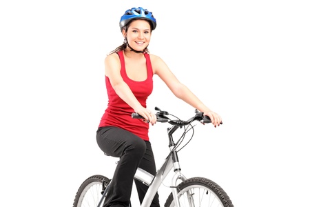 Female biker with helmet posing next to a bike isolated against white backgroundの写真素材
