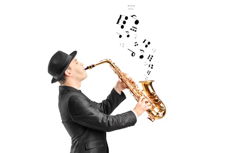 A male playing on saxophone and notes coming out isolated against backgroundの写真素材