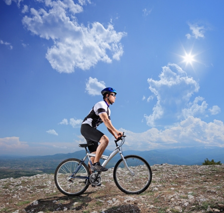 A young biker biking a mountain bike on a sunny day の写真素材