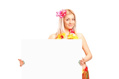 An attractive young woman dressed in a hawaiian costume holding a  panel isolated on white backgroundの写真素材
