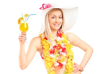 Portrait of a female dressed in a hawaiian costume holding an orange cocktail isolated on white の写真素材