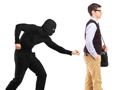 A pickpocket with mask trying to steal a wallet isolated on white backgroundの写真素材