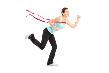 Full length portrait of a female runner winning a marathon, isolated on white backgroundの写真素材