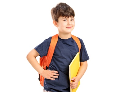 A school boy with backpack holding a notebook isolated against white backgroundの写真素材
