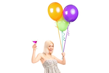 An attractive woman holding balloons and cocktail isolated against white backgroundの写真素材