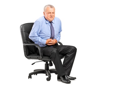 Businessman having a stomach ache isolated on white backgroundの写真素材