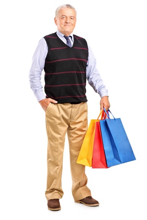 Full length portrait of a mature man with shopping bags isolated on white backgroundの写真素材