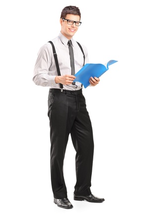 Full length portrait of a professional young man holding a fascicule isolated on white backgroundの写真素材