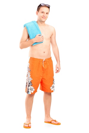 Full length portrait of a young male in bathing clothes isolated against white backgroundの写真素材