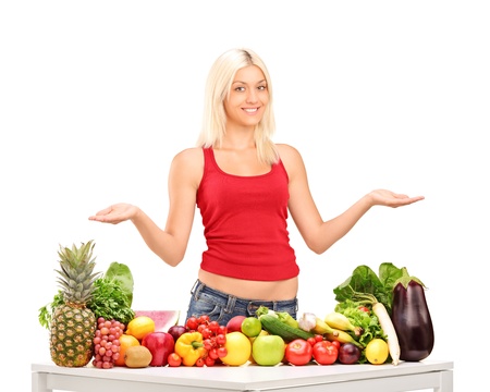 Young female with fruits and vegetables isolated on white backgroundの写真素材