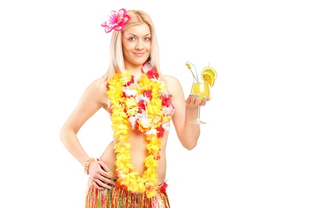 An attractive young woman dressed in a hawaiian costume drinking cocktail isolated on white backgroundの写真素材
