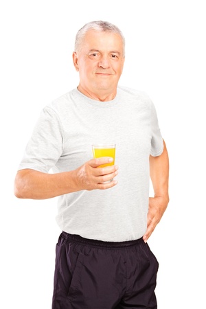 Mature athlete holding a glass of orange juice, refreshing after an exercise, isolated on white backgroundの写真素材