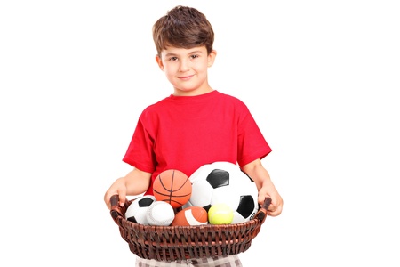 A boy holding a basket with balls, isolated on white backgroundの写真素材