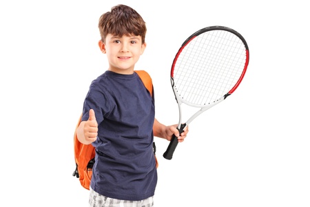 A child holding a tennis racket and giving thumb up isolated on white backgroundの写真素材