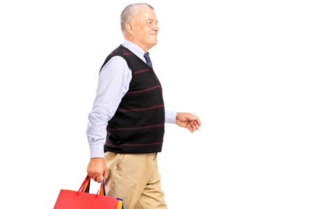 A mature man coming back after shopping isolated on white backgroundの写真素材