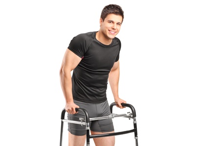 A young smiling athlete using a walker isolated on white backgroundの写真素材