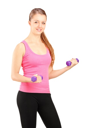 Active young female lifting weights isolated on white backgroundの写真素材