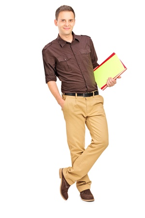 Full length portrait of a smiling student leaning against wall isolated on white backgroundの写真素材