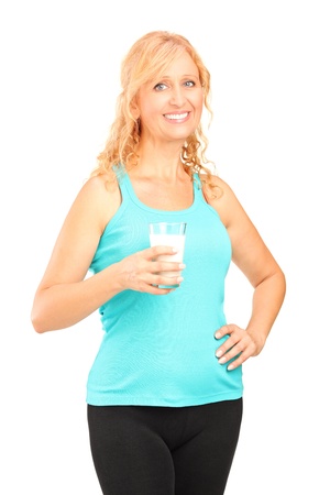 Woman holding a glass of milk isolated on white backgroundの写真素材