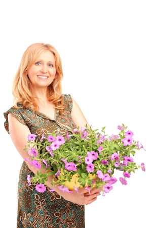 A mature female holding flowers isolated on white backgroundの写真素材