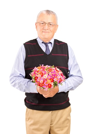 A mature gentleman holding bouquet of flowers isolated on white backgroundの写真素材