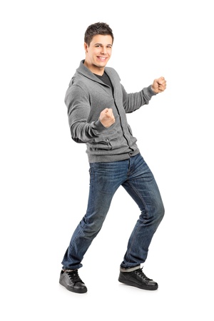 Full length portrait of a young male gesturing happiness isolated on white backgroundの写真素材