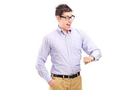 Portrait of a man looking at his watch isolated on white backgroundの写真素材