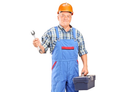 A manual worker holding a wrench and tool box isolated against white backgroundの写真素材