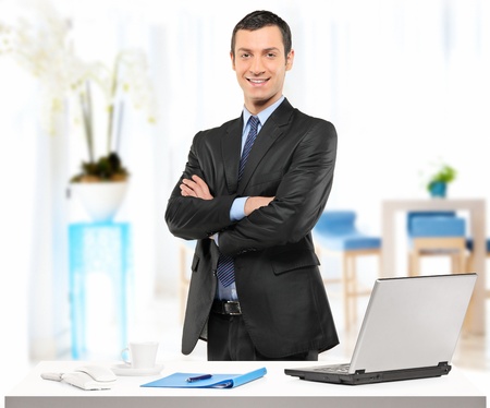 A confident young businessman posing in his officeの写真素材