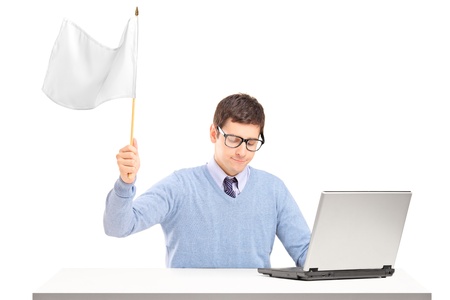 Sad man waving a white flag gesturing defeat isolated on white backgroundの写真素材
