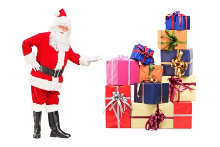 Full length portrait of a Santa Claus offering presents isolated on white backgroundの写真素材