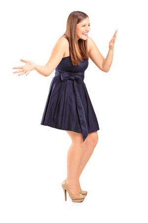 Full length portrait of an excited young female against white backgroundの写真素材